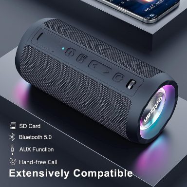 Haut-parleur portable noir avec éclairage LED et options de connectivité variées.